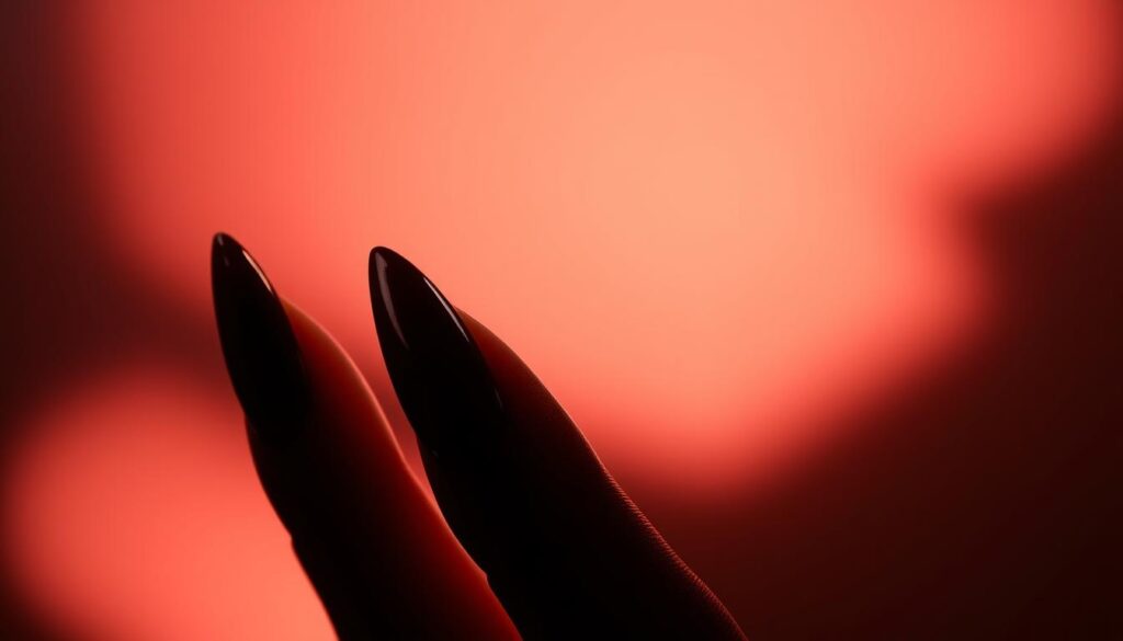 Dramatic dark red stiletto nails against a soft, ethereal background. Gleaming, razor-sharp tips cast in dramatic chiaroscuro lighting, the nails' surfaces glistening with an otherworldly sheen. The nails gracefully extend, each one a precise, tapered point evoking a sense of refined elegance and effortless allure. Subtle gradients of scarlet and burgundy create depth and dimension, while discreet highlights accentuate the nails' sculpted, feminine form. An atmospheric, moody ambiance envelops the scene, setting the stage for a captivating, high-fashion editorial.